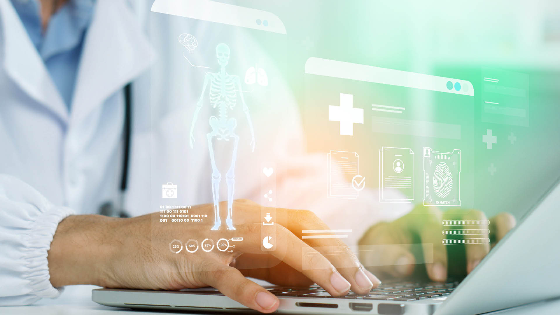 Hände tippen auf Laptop, darüber digitale medizinische Elemente