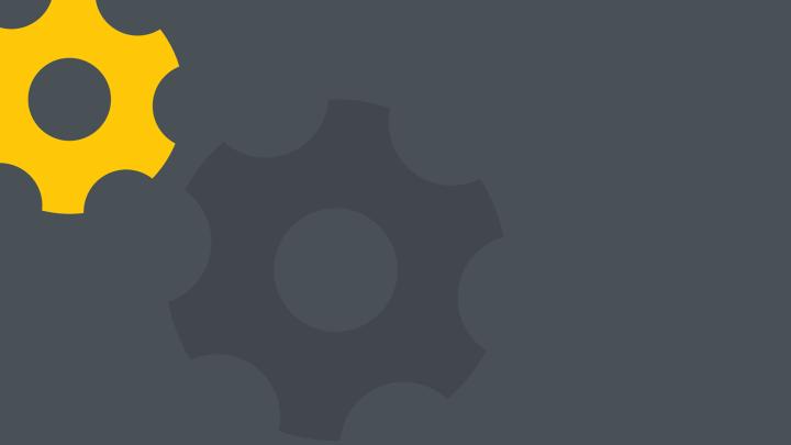 Ein gelbes und ein dunkelgraues Zahnrad auf grauem Hintergrund.